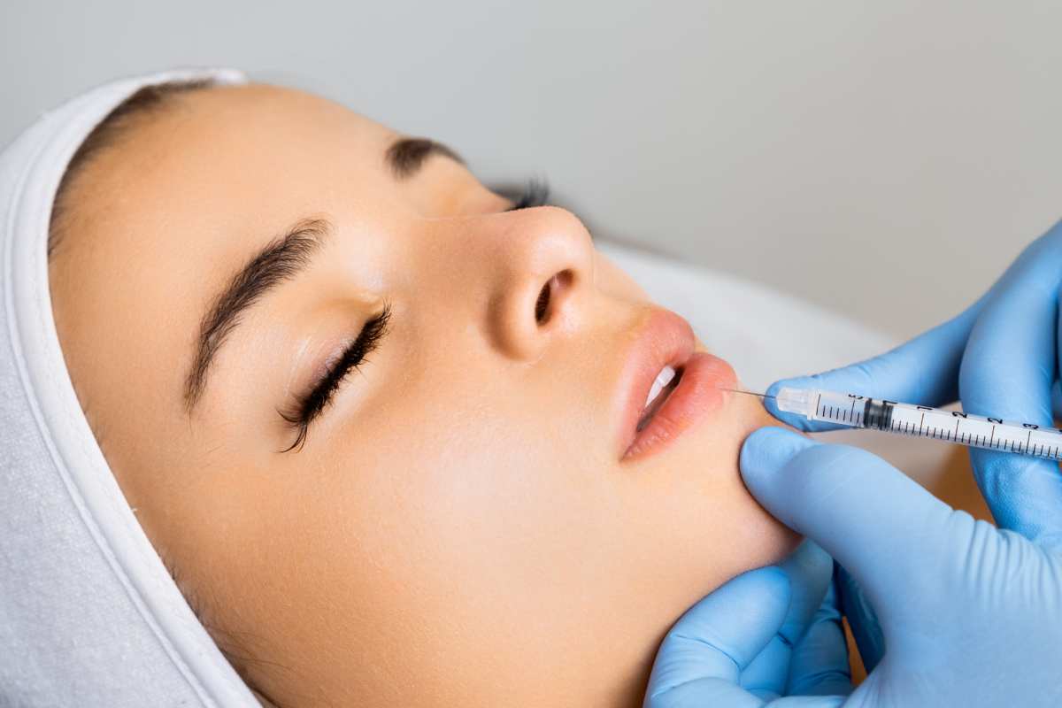 A women getting inject with lip filler